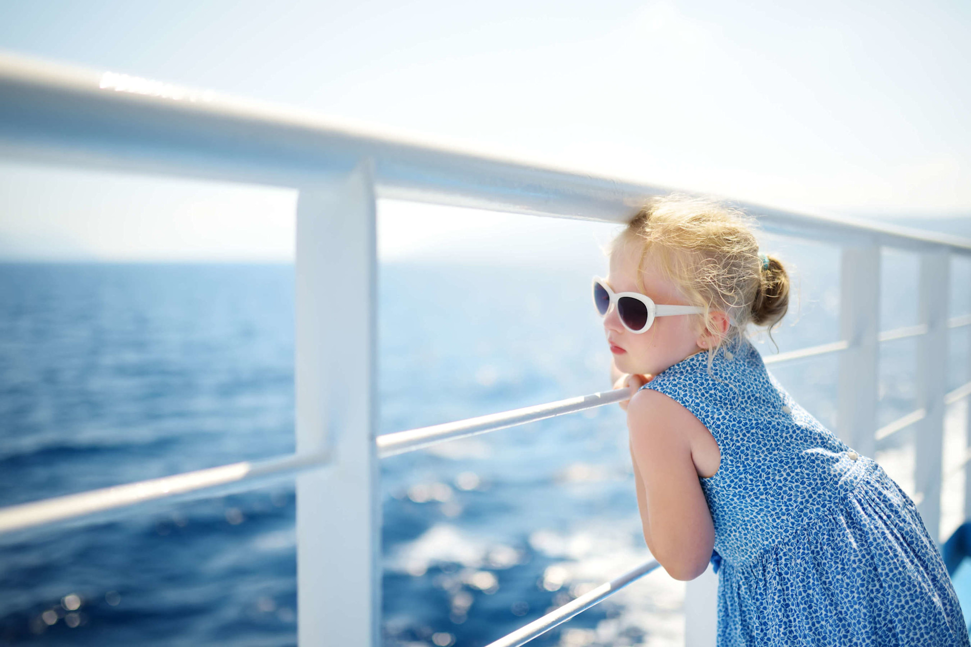 Girl with sunglasses on deck of ship