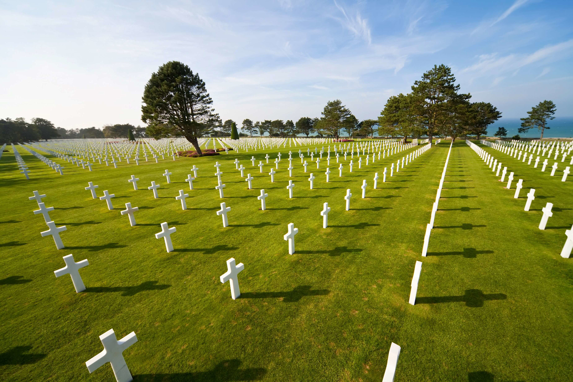 Graves marked by white crosses at the Normandy American Cemetery above Omaha Beach