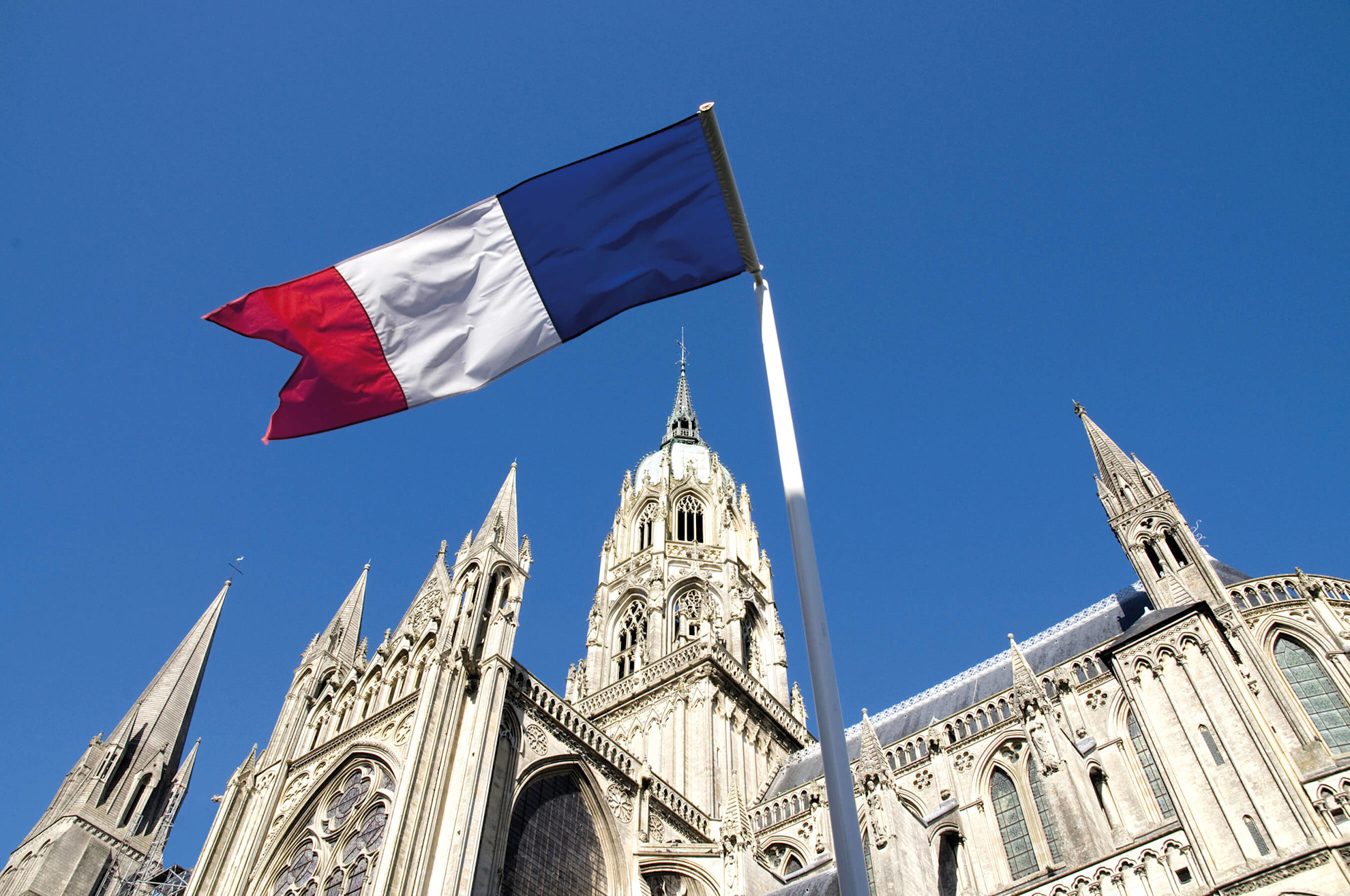 Bayeux cathedral with French flag © Shutterstock