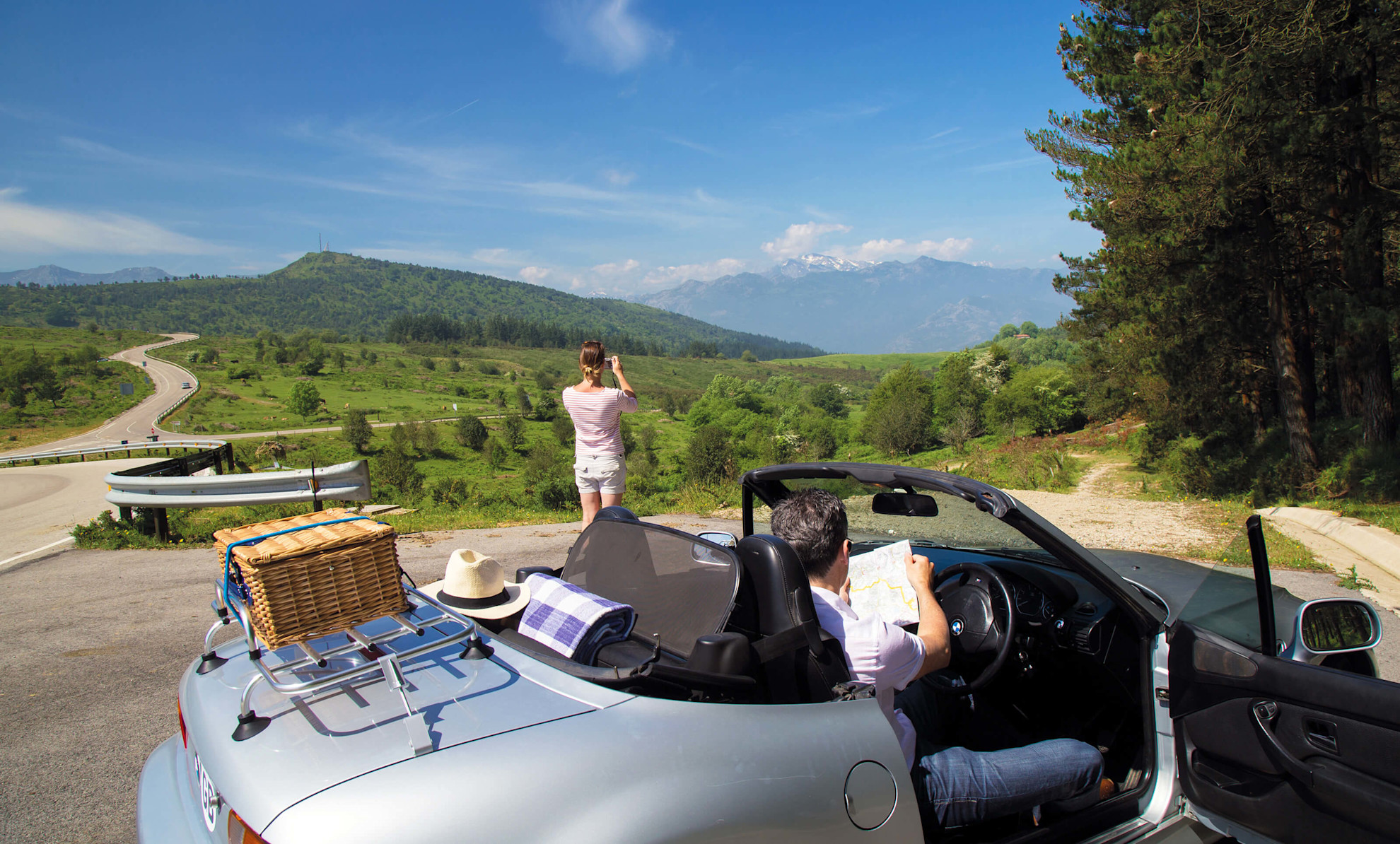 Woman taking a photo of spectacular views, Cantabria, Spain