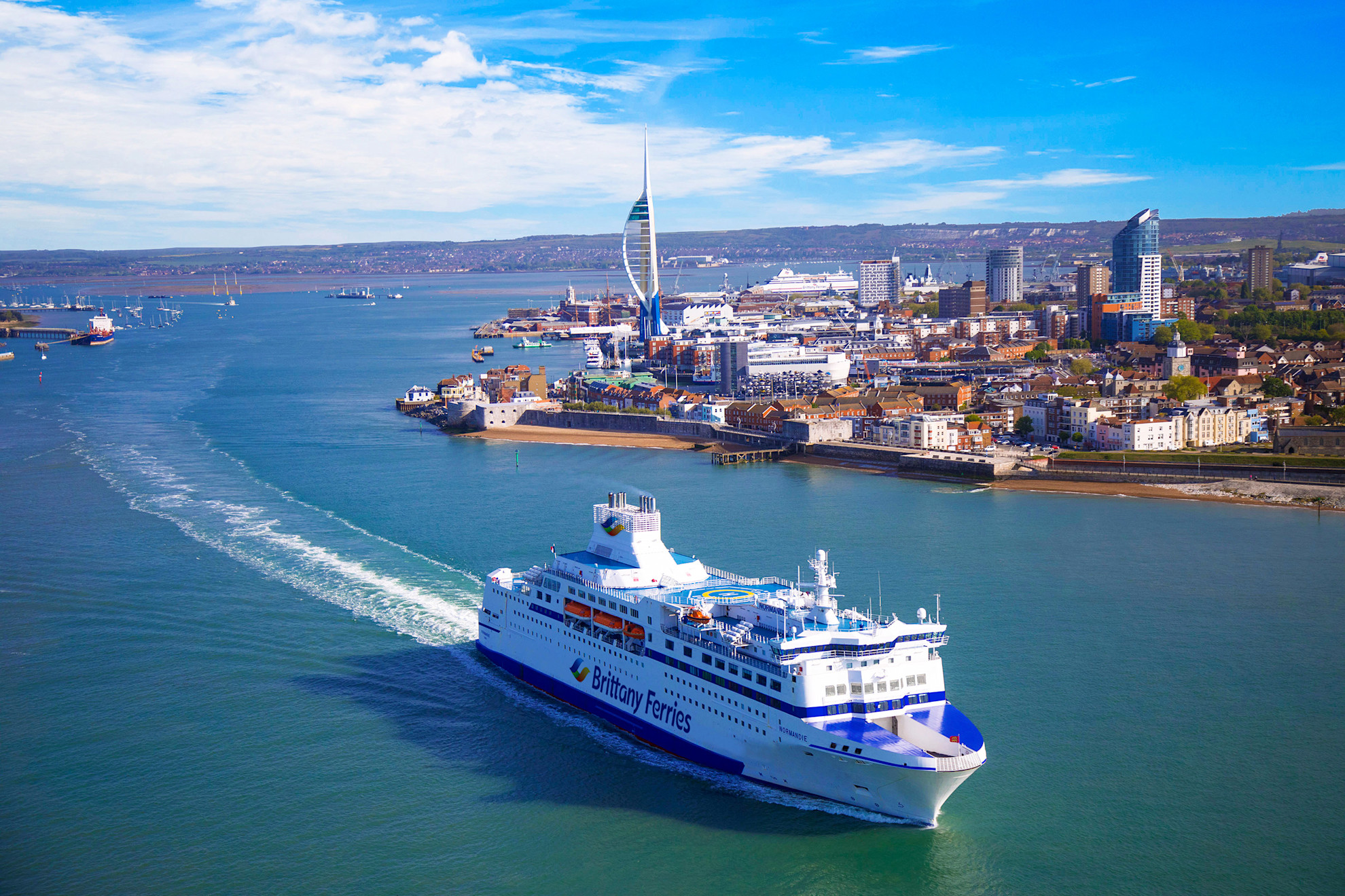 Aerial view of Normandie sailing out of Portsmouth