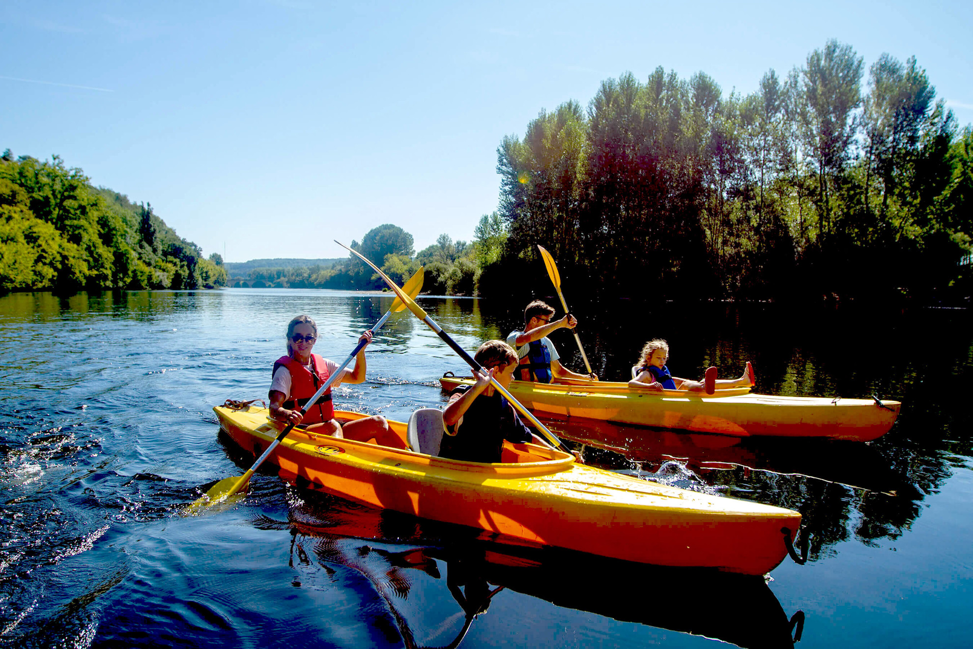 Family in kayaks on a lake
