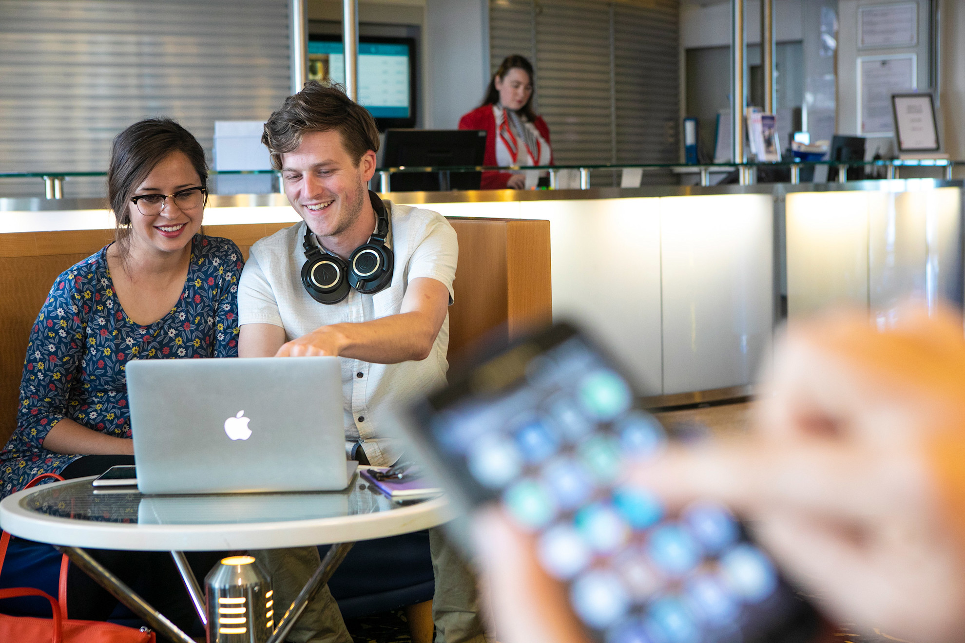 A couple using a laptop and on board