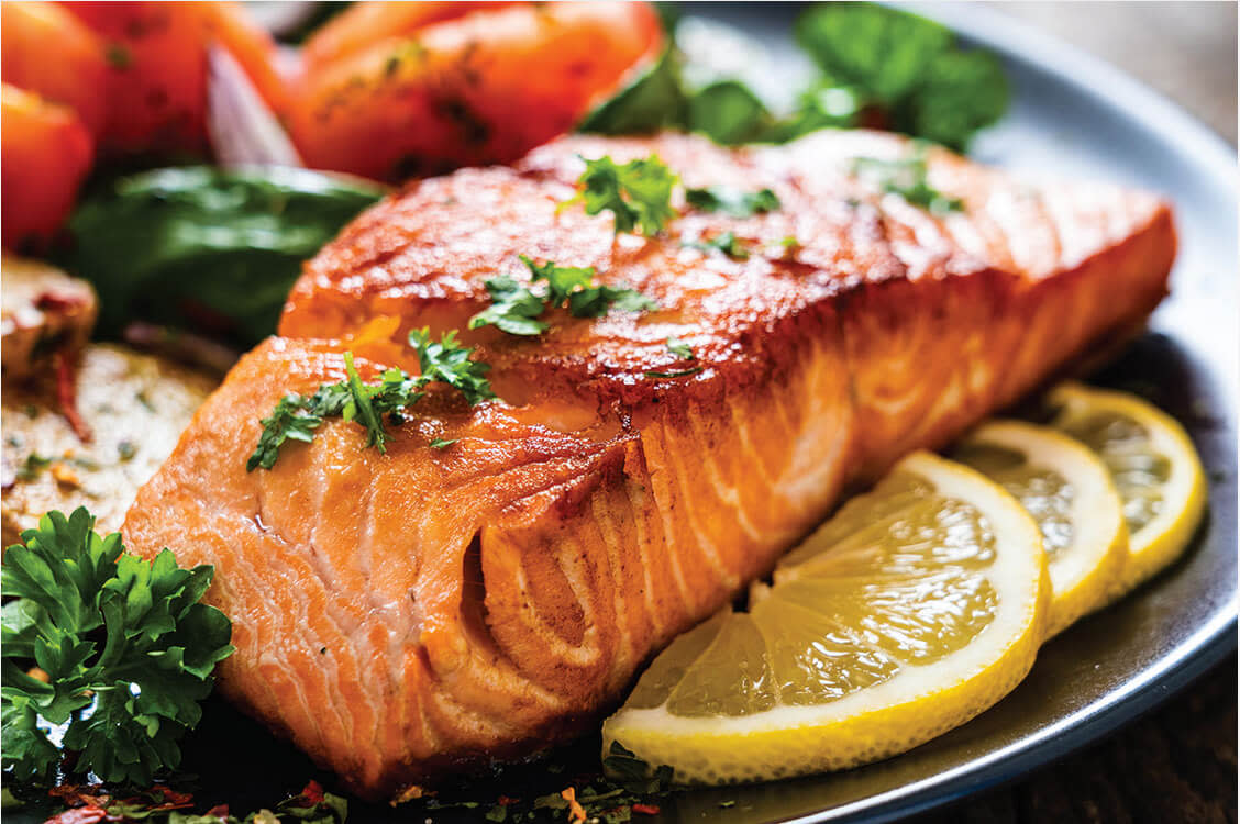 Close up of a plate with smoked salmon and salad