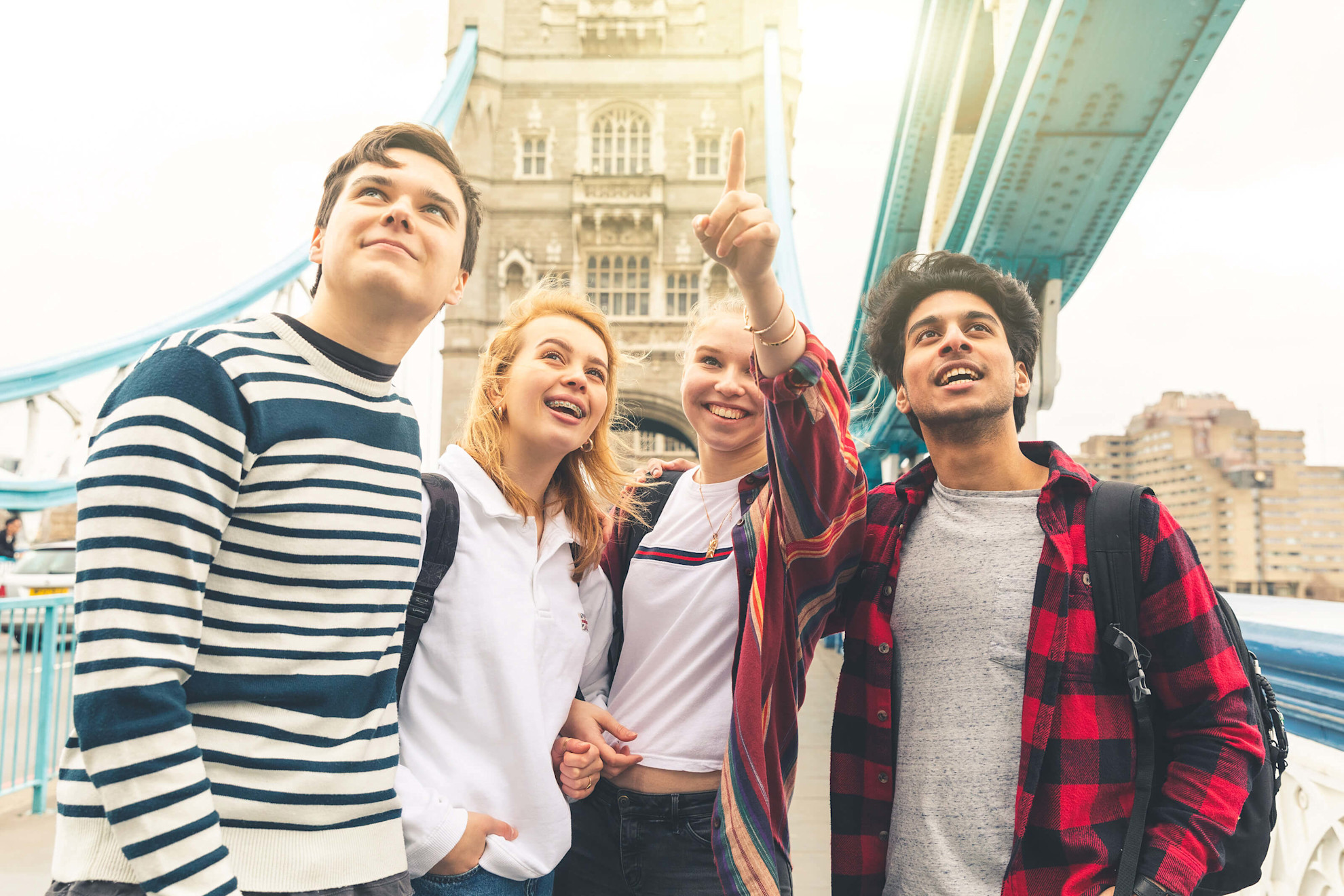Happy students on Tower Bridge in London during school trip